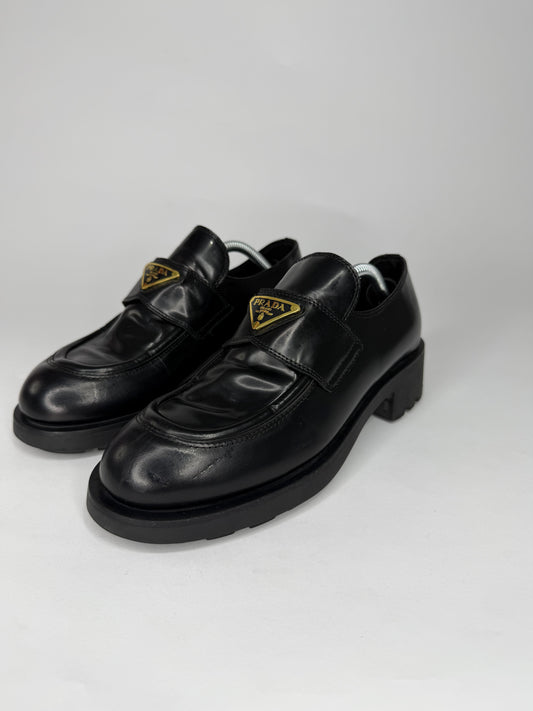 Prada
Enameled Metal Triangle Leather Loafers
Women's Size 38 EU/ 8 US