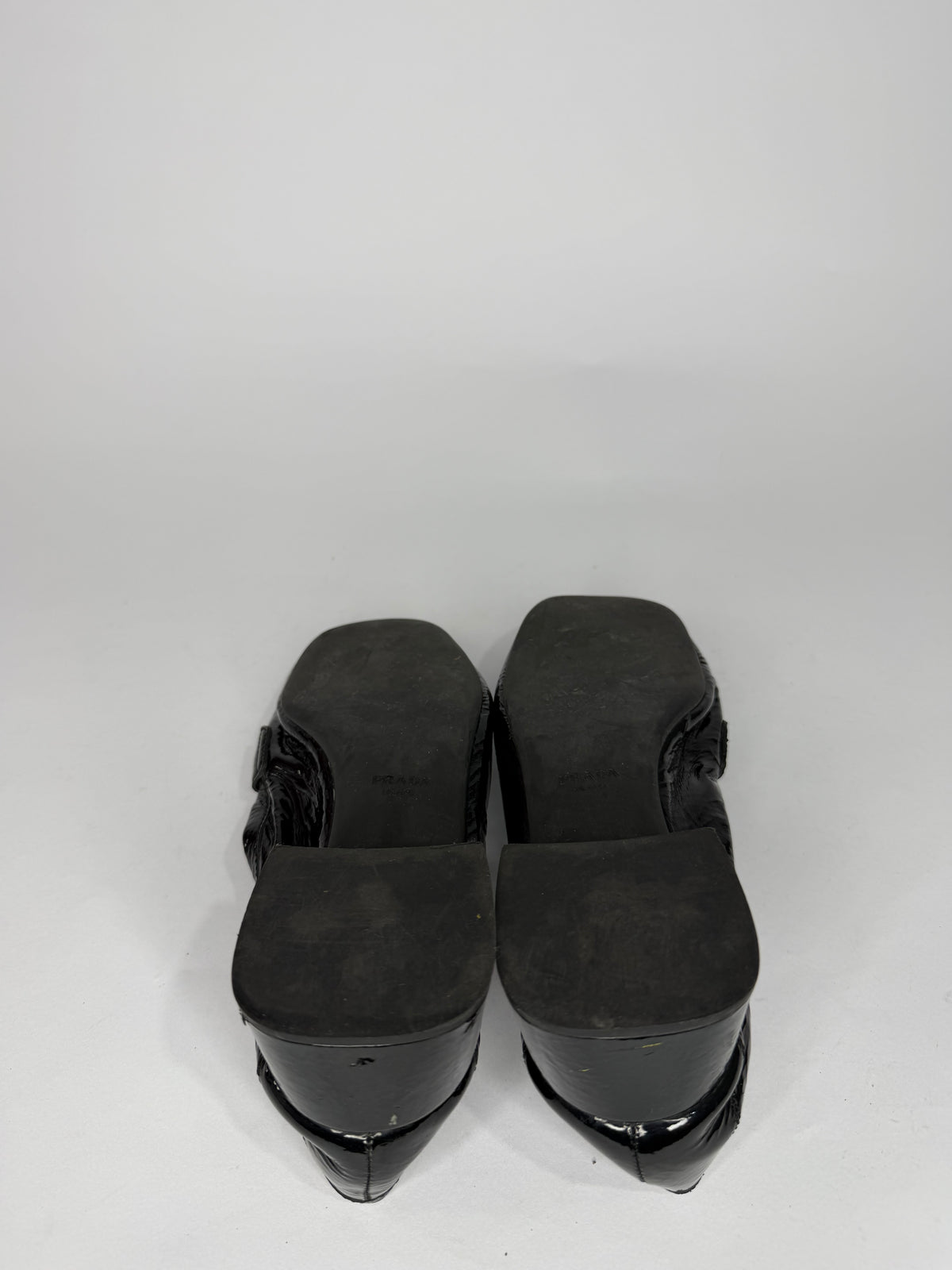 Prada
Enameled Metal Triangle Leather Loafers
Women's Size 37.5 EU/ 7.5 US/ 4.5 UK