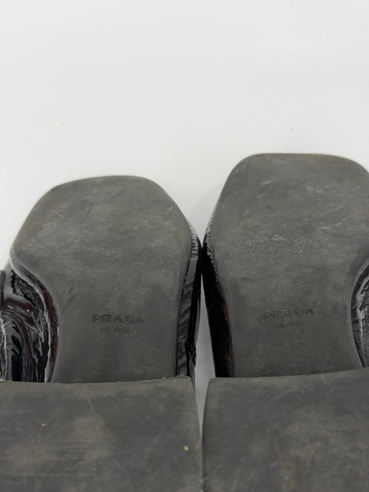 Prada
Enameled Metal Triangle Leather Loafers
Women's Size 37.5 EU/ 7.5 US/ 4.5 UK