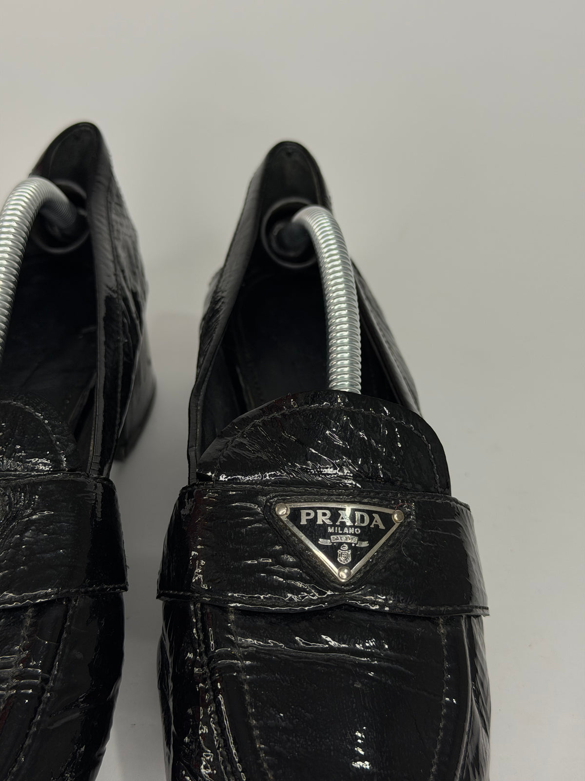Prada
Enameled Metal Triangle Leather Loafers
Women's Size 37.5 EU/ 7.5 US/ 4.5 UK