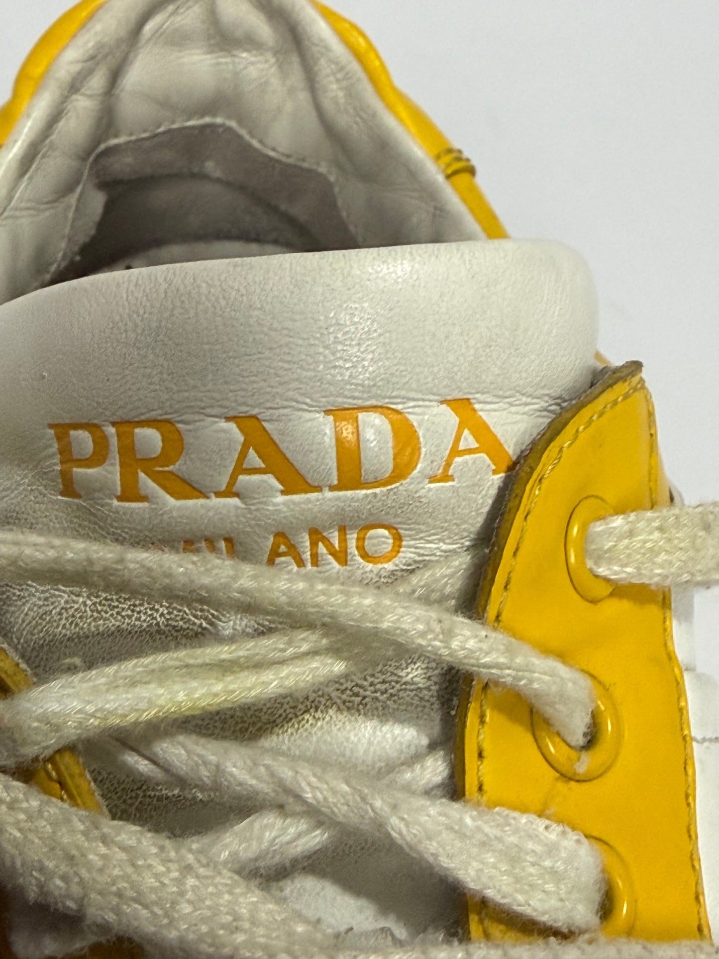 Prada
Enameled Metal Triangle Leather Sneakers