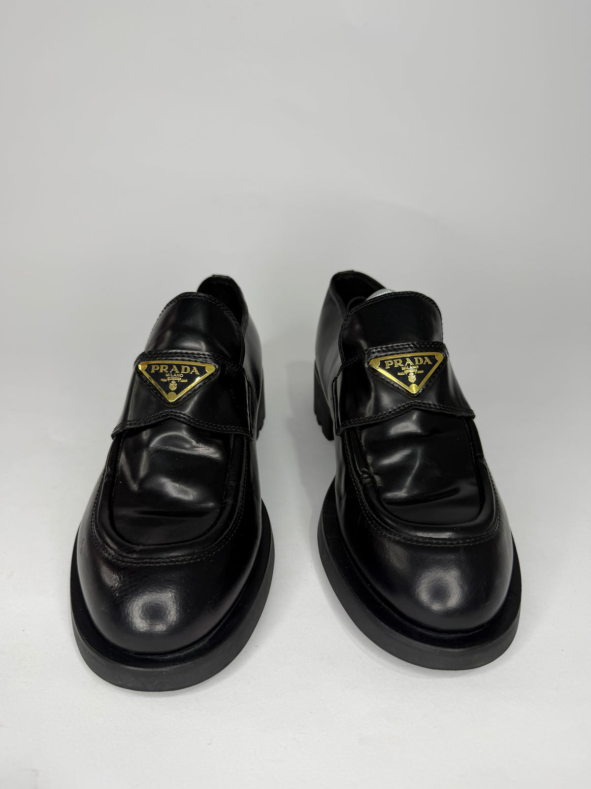 Prada
Enameled Metal Triangle Leather Loafers
Women's Size 38 EU/ 8 US