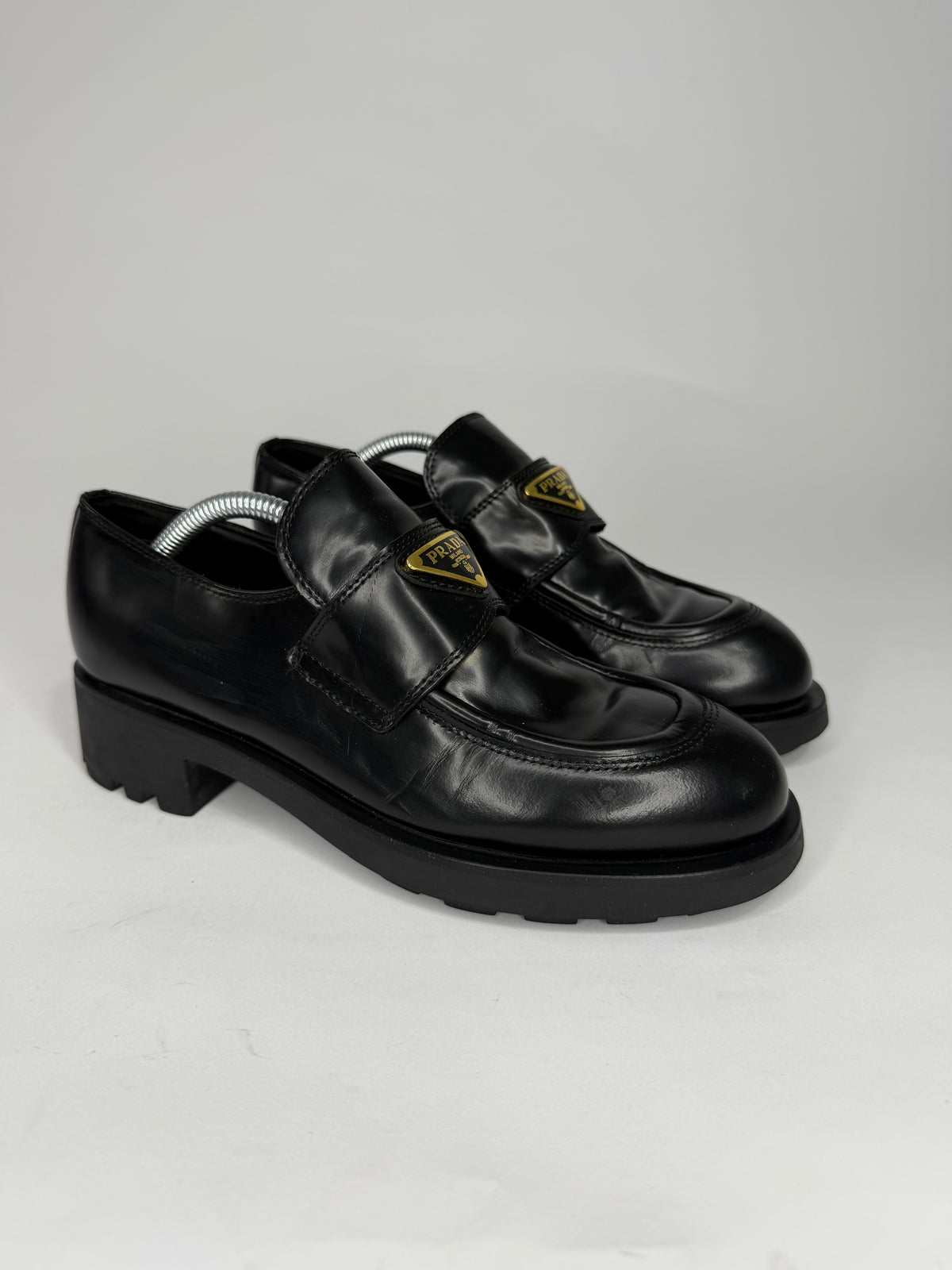 Prada
Enameled Metal Triangle Leather Loafers
Women's Size 38 EU/ 8 US