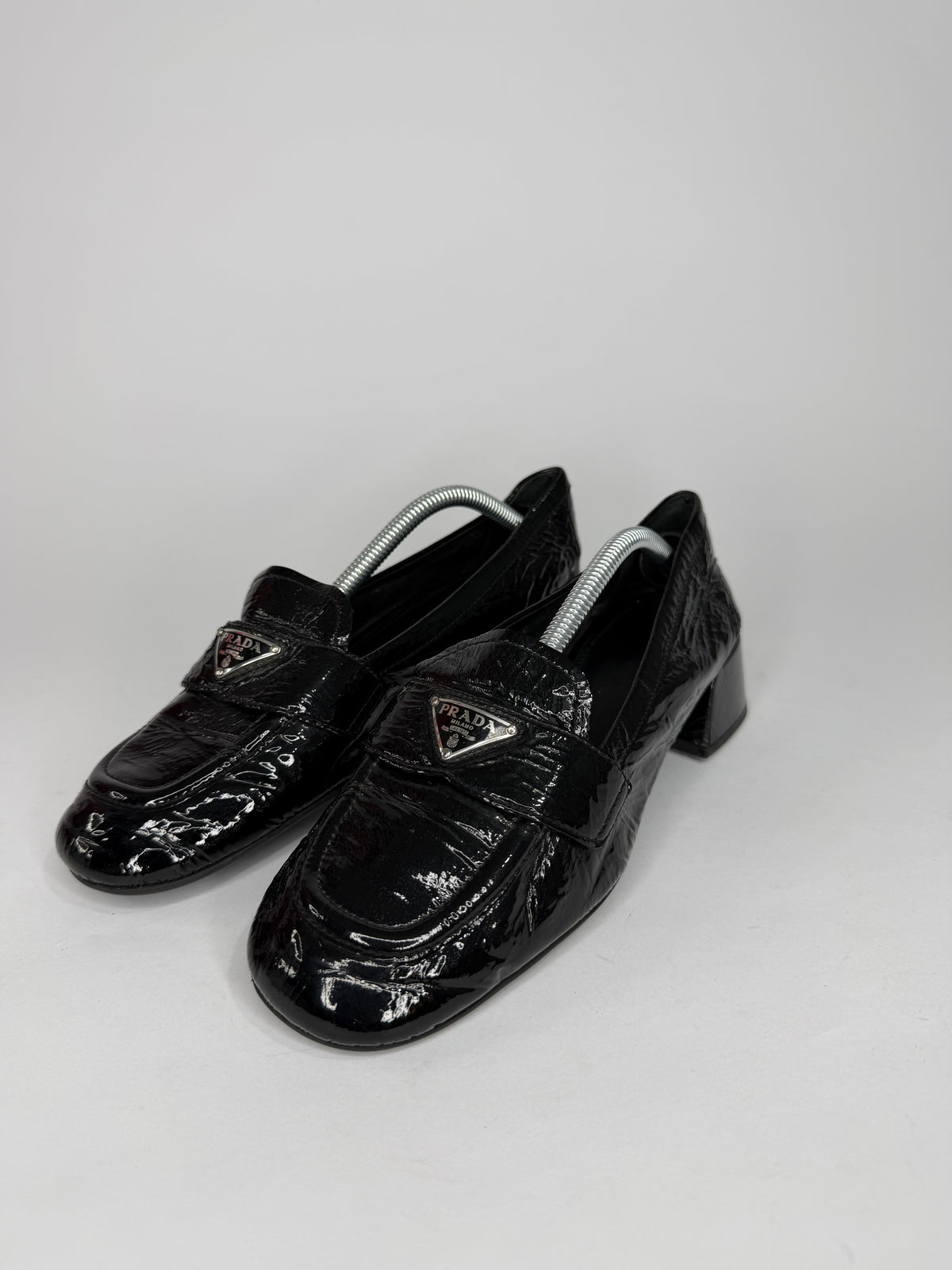 Prada
Enameled Metal Triangle Leather Loafers
Women's Size 37.5 EU/ 7.5 US/ 4.5 UK