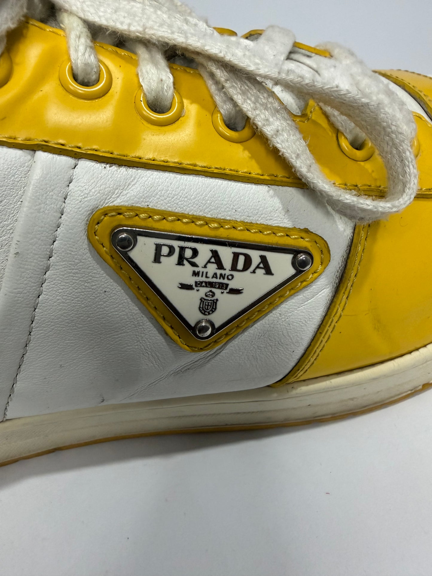 Prada
Enameled Metal Triangle Leather Sneakers