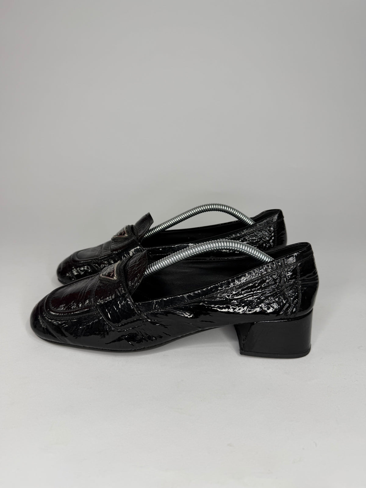 Prada
Enameled Metal Triangle Leather Loafers
Women's Size 37.5 EU/ 7.5 US/ 4.5 UK