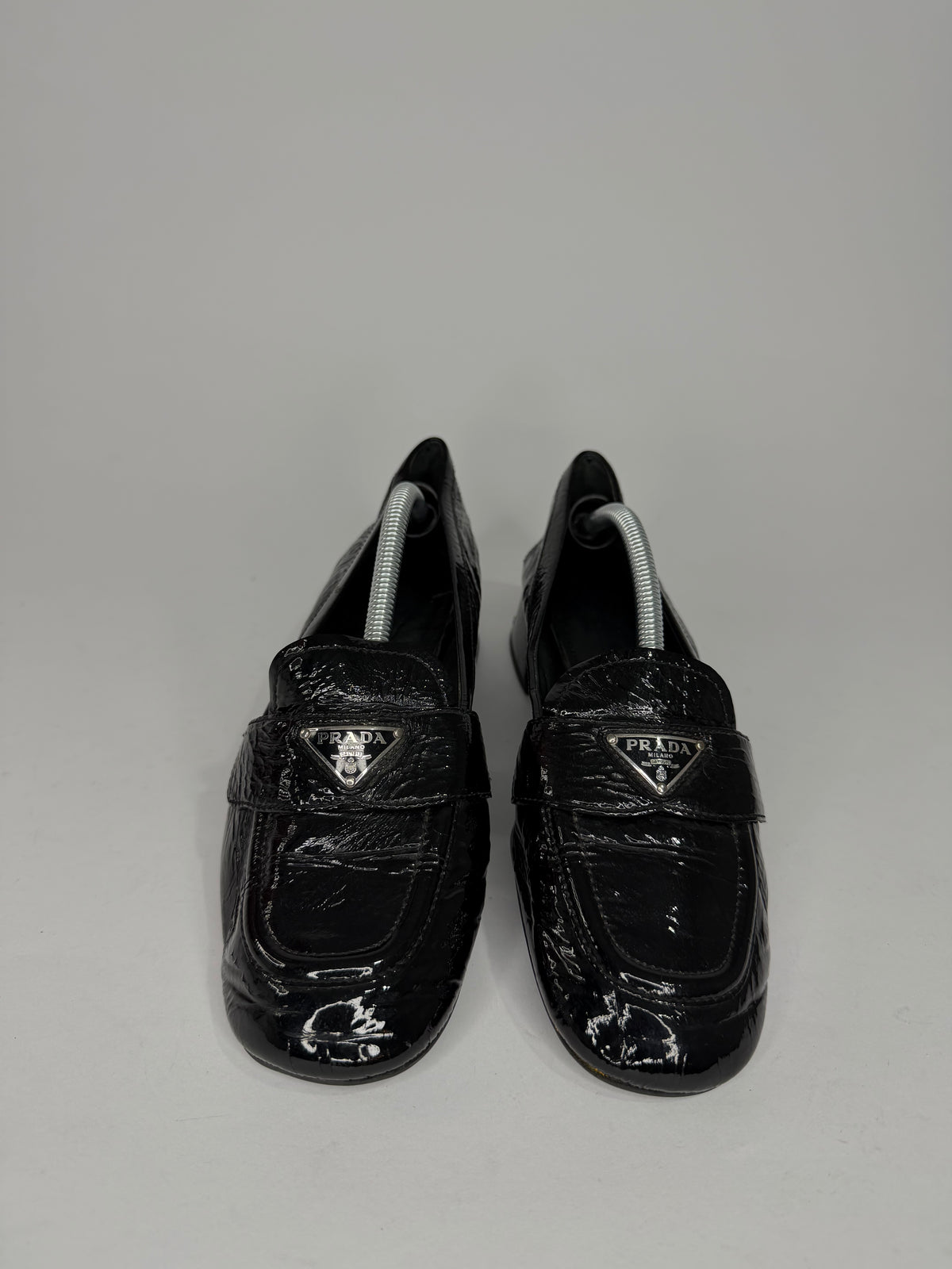 Prada
Enameled Metal Triangle Leather Loafers
Women's Size 37.5 EU/ 7.5 US/ 4.5 UK