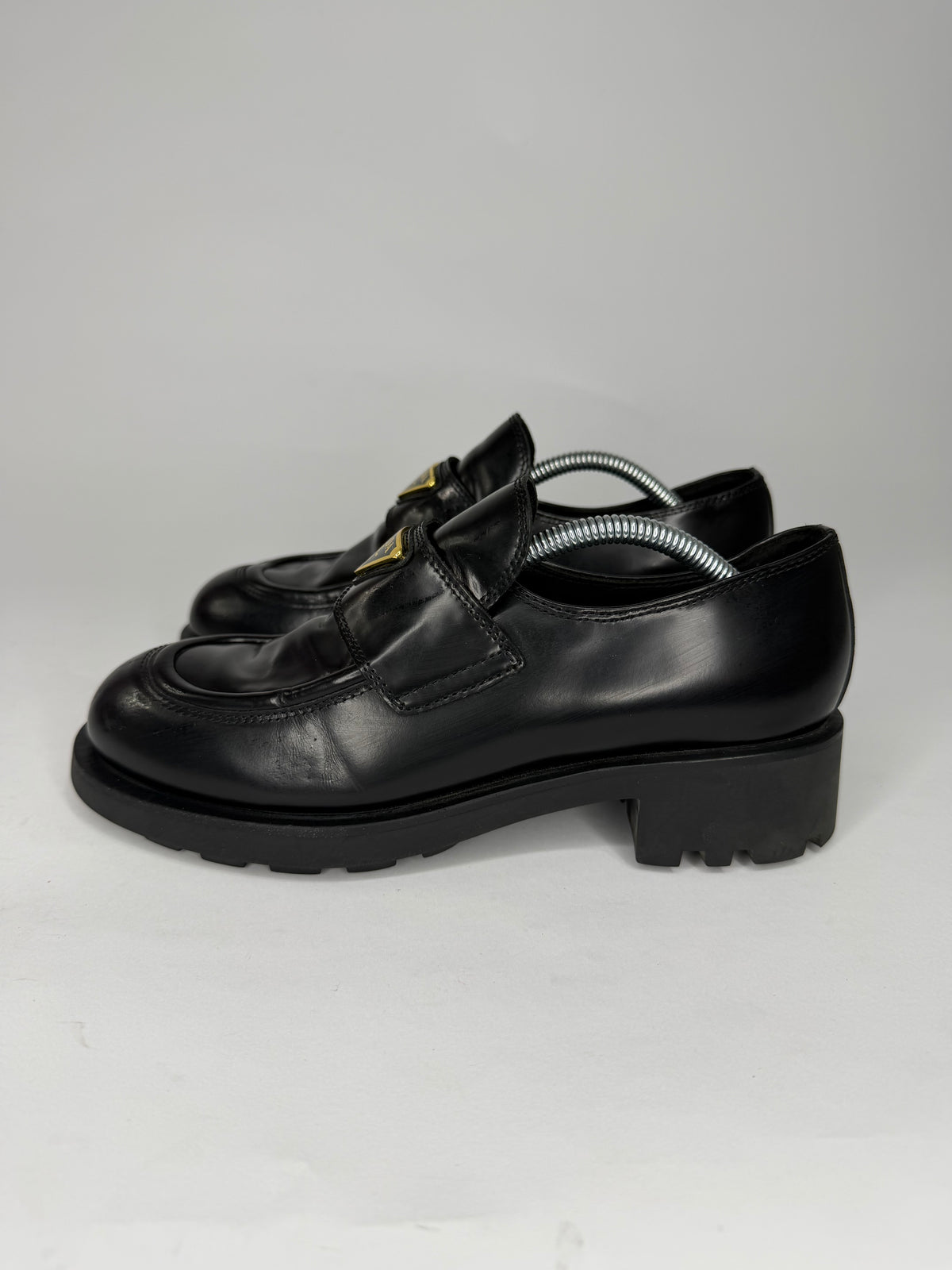 Prada
Enameled Metal Triangle Leather Loafers
Women's Size 38 EU/ 8 US