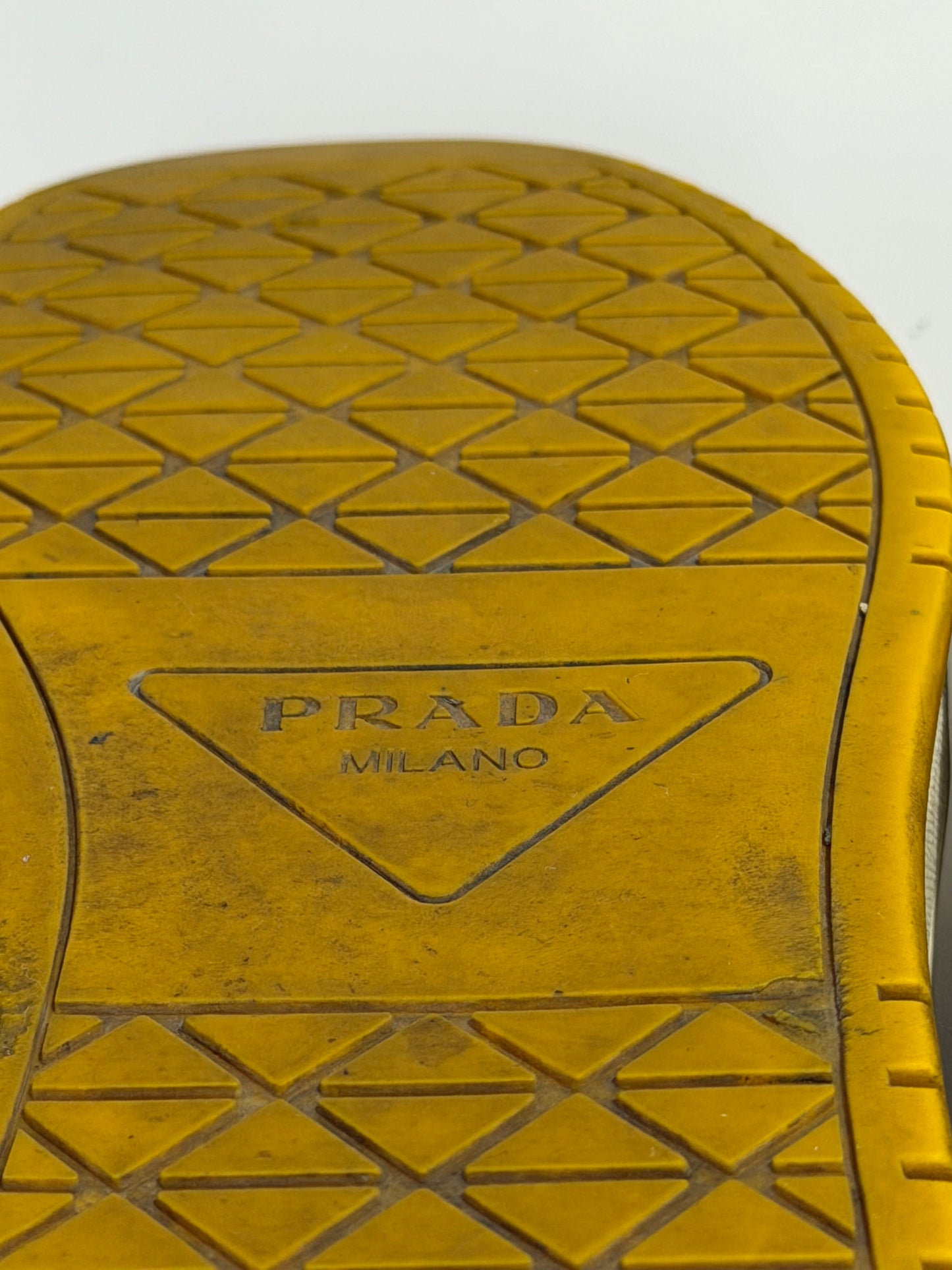 Prada
Enameled Metal Triangle Leather Sneakers