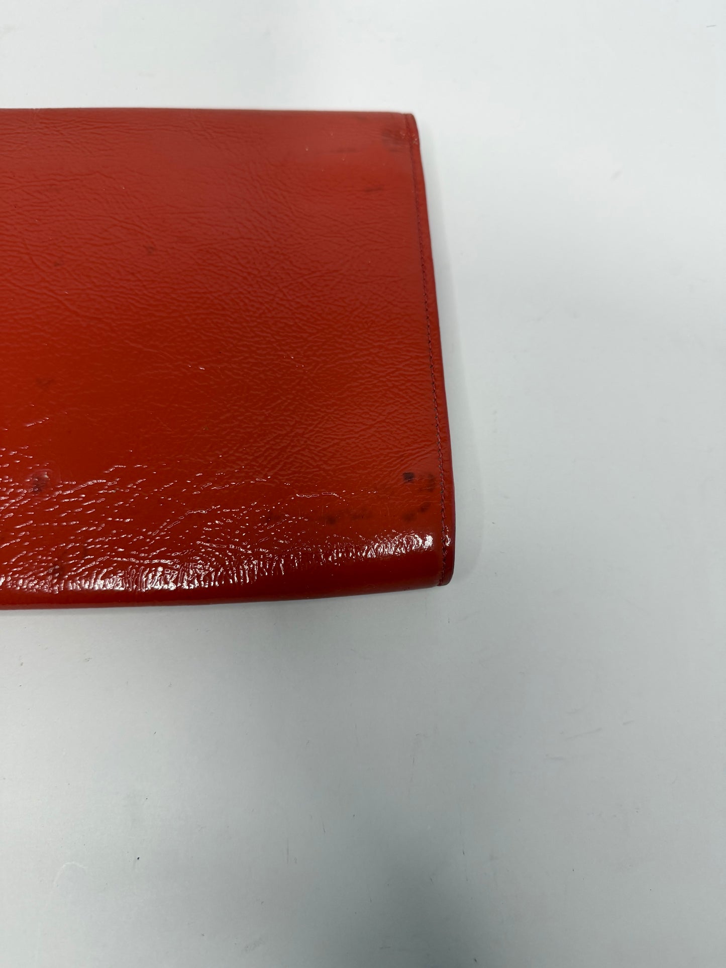 YVES SAINT LAURENT
Dark Orange Patent Leather Belle De Jour Large Clutch Bag
