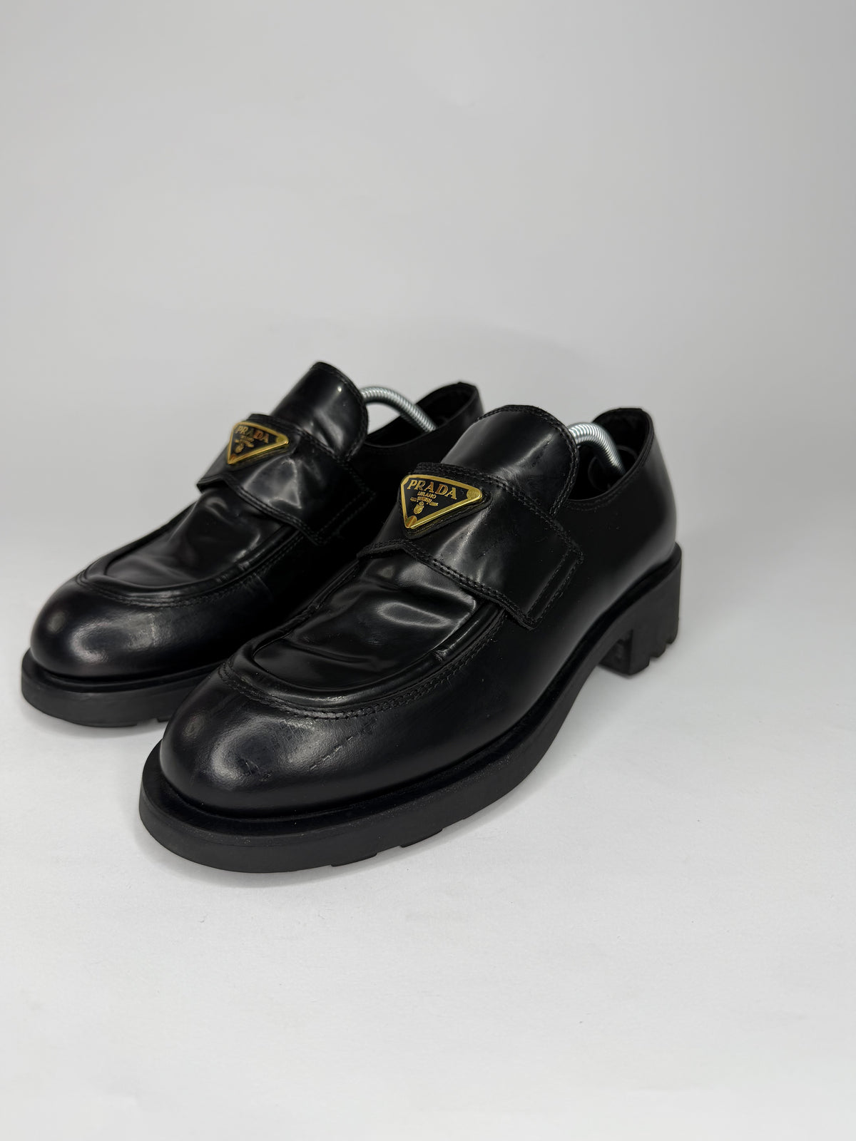 Prada
Enameled Metal Triangle Leather Loafers
Women's Size 38 EU/ 8 US