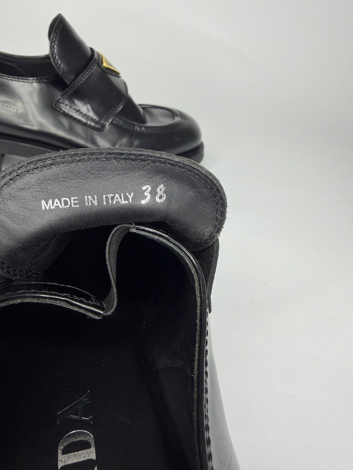 Prada
Enameled Metal Triangle Leather Loafers
Women's Size 38 EU/ 8 US
