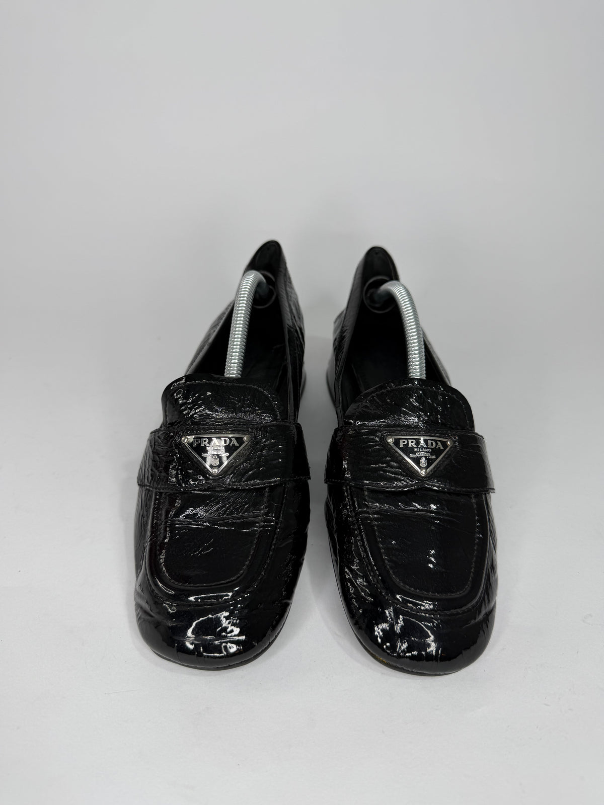 Prada
Enameled Metal Triangle Leather Loafers
Women's Size 37.5 EU/ 7.5 US/ 4.5 UK