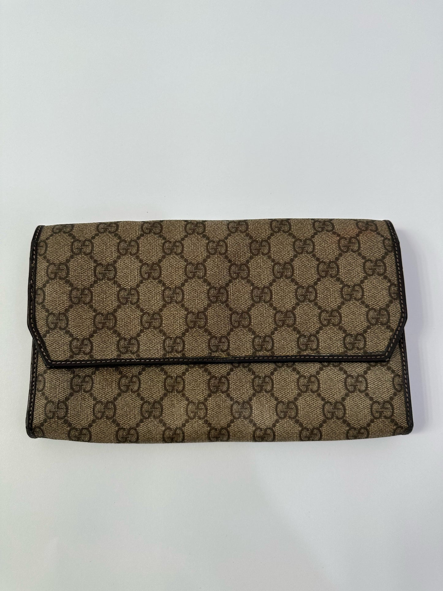 GUCCI 
GG Supreme Monogram Clutch Document Holder Brown